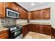 Kitchen features stainless steel appliances, including a range and a microwave, with granite countertops at 1132 Hardy Ave Ave, Orlando, FL 32803