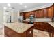 Open kitchen showcasing wood cabinets, a granite island, and stainless steel appliances at 1132 Hardy Ave Ave, Orlando, FL 32803