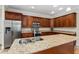 Bright kitchen featuring wood cabinets, granite countertops, and stainless steel appliances at 1132 Hardy Ave Ave, Orlando, FL 32803