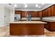 Spacious kitchen featuring wood cabinetry, stainless steel appliances, and granite countertops at 1132 Hardy Ave Ave, Orlando, FL 32803