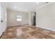 Open-concept living room featuring tile flooring, recessed lighting, and a view of the half bathroom at 1132 Hardy Ave Ave, Orlando, FL 32803