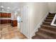 Carpeted staircase leading to the upper level, with a glimpse of the kitchen at 1132 Hardy Ave Ave, Orlando, FL 32803