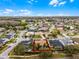 An aerial perspective of a house in a community features nearby ponds and a host of local homes at 13506 Crystal River Dr, Orlando, FL 32828