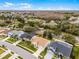 Aerial view captures homes near a highway in a landscape dotted with trees against a skyline at 13506 Crystal River Dr, Orlando, FL 32828