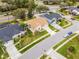 An aerial view showcasing a well-maintained property with lush landscaping and a charming beige exterior at 13506 Crystal River Dr, Orlando, FL 32828