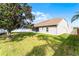 Wide backyard showing partial lawn and tree coverage. A white fence lines the property at 13506 Crystal River Dr, Orlando, FL 32828