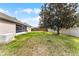 Spacious backyard features a lush lawn, mature landscaping, and a white perimeter fence at 13506 Crystal River Dr, Orlando, FL 32828