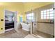 Bright bathroom featuring a standalone tub, tiled shower with glass door, and tiled floor at 13506 Crystal River Dr, Orlando, FL 32828