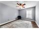 Simple bedroom with hardwood floors, a ceiling fan, plantation shutters and a comfortable area rug at 13506 Crystal River Dr, Orlando, FL 32828