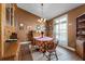 Traditional dining room features wood floors, complementary furniture and natural light from the shuttered windows at 13506 Crystal River Dr, Orlando, FL 32828