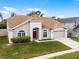 Well-maintained single-story home with a manicured lawn and a two-car garage at 13506 Crystal River Dr, Orlando, FL 32828