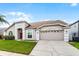 Inviting single-Gathering home with well-maintained landscaping and a spacious driveway at 13506 Crystal River Dr, Orlando, FL 32828
