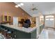 Kitchen counter with bar stool seating overlooking open layout with pendant lighting and ceiling fan at 13506 Crystal River Dr, Orlando, FL 32828