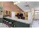 Open kitchen with breakfast bar, wood cabinets, and modern appliances at 13506 Crystal River Dr, Orlando, FL 32828