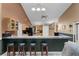 Kitchen counter with bar stool seating overlooking open layout with pendant lighting and ceiling fan at 13506 Crystal River Dr, Orlando, FL 32828