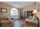 Comfortable living room with plantation shutters, rich wood floors, and built-in shelving for a cozy ambiance at 13506 Crystal River Dr, Orlando, FL 32828