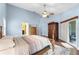 Light-filled main bedroom boasts a ceiling fan, en-suite bath access, closet space, and patio access at 13506 Crystal River Dr, Orlando, FL 32828