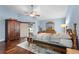 Bright bedroom featuring wood floors, ceiling fan, and large windows with shutters, offering natural light at 13506 Crystal River Dr, Orlando, FL 32828