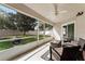 Covered screened-in patio featuring an outdoor seating area and a view of the landscaped backyard at 13506 Crystal River Dr, Orlando, FL 32828