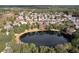 An aerial image featuring a tranquil pond surrounded by trees and houses in a residential neighborhood at 1382 Hayton Ave, Deland, FL 32724