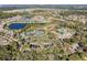 An aerial view showcasing tennis courts, a pool, and a clubhouse, nestled within a thriving community at 1382 Hayton Ave, Deland, FL 32724