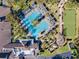 Overhead view of a community pool and clubhouse, complete with lounge chairs and palm trees at 1382 Hayton Ave, Deland, FL 32724