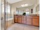 Bathroom features a double vanity, a glass shower, and a soaking tub at 1382 Hayton Ave, Deland, FL 32724