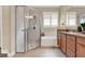 Bathroom featuring glass shower and a soaking tub with wood cabinets and granite countertop at 1382 Hayton Ave, Deland, FL 32724