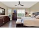 Comfortable bedroom featuring hardwood floors, a ceiling fan, and shuttered windows for natural light at 1382 Hayton Ave, Deland, FL 32724