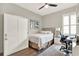 Bedroom with a bed, wardrobe, desk, and white shutters for bright natural lighting at 1382 Hayton Ave, Deland, FL 32724
