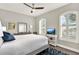 Bedroom featuring white bedding, shuttered windows, and a ceiling fan for optimal comfort at 1382 Hayton Ave, Deland, FL 32724