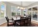 Inviting dining room featuring plantation shutters and a sliding glass door at 1382 Hayton Ave, Deland, FL 32724