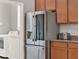 Modern stainless steel refrigerator and appliances are next to the utility room, complete with a new washer and dryer at 1382 Hayton Ave, Deland, FL 32724