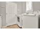 Laundry room featuring a white washer and dryer beside a white door and tile floors at 1382 Hayton Ave, Deland, FL 32724