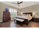 Relaxing main bedroom boasts a king bed, ceiling fan, and plantation shutters for natural light at 1382 Hayton Ave, Deland, FL 32724
