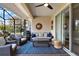 Cozy screened patio featuring a ceiling fan, comfortable seating, and elegant decor for outdoor relaxation at 1382 Hayton Ave, Deland, FL 32724