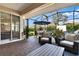 Stylish screened patio featuring an outdoor dining area, inviting seating, and sliding glass door access at 1382 Hayton Ave, Deland, FL 32724