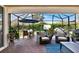 Charming screened patio with an outdoor dining area, comfortable seating, and lush green views at 1382 Hayton Ave, Deland, FL 32724