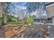 The lush backyard features mature trees and an enclosed patio at 1409 Overlake Ave, Orlando, FL 32806