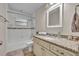 Updated bathroom with granite vanity and a bathtub with tiled walls and shower at 1409 Overlake Ave, Orlando, FL 32806