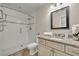 Updated bathroom featuring a granite vanity, and a shower with glass doors and tiled walls at 1409 Overlake Ave, Orlando, FL 32806