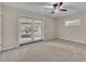 Bright bedroom with carpet, ceiling fan, and glass doors leading to the outside at 1409 Overlake Ave, Orlando, FL 32806