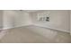 Neutral-colored bedroom featuring plush carpeting, a large window for natural light, and ample space for furnishings at 1409 Overlake Ave, Orlando, FL 32806