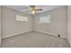 Clean bedroom with carpet, ceiling fan, neutral walls, and two windows at 1409 Overlake Ave, Orlando, FL 32806