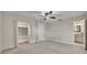 Spacious bedroom with carpet, ceiling fan, walk-in closet, and bathroom access at 1409 Overlake Ave, Orlando, FL 32806
