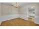 Elegant dining room featuring hardwood floors, decorative wainscoting, and a beautiful chandelier at 1409 Overlake Ave, Orlando, FL 32806