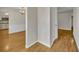 Inviting hallway features hardwood floors, neutral walls, and views into the dining area and kitchen at 1409 Overlake Ave, Orlando, FL 32806