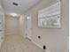 Bright laundry room with tile flooring, a window, and access to outside at 1409 Overlake Ave, Orlando, FL 32806