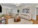 Tastefully furnished living room with hardwood floors, neutral walls, and a view into the dining area at 1409 Overlake Ave, Orlando, FL 32806