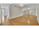 Open-concept living space showcasing hardwood floors and seamless transition between living room, dining room and kitchen at 1409 Overlake Ave, Orlando, FL 32806